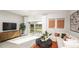 Sun-filled living room with a modern television, neutral color palette, and cozy seating at 2520 Penguin Blvd, Davenport, FL 33837