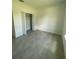 Bedroom featuring neutral walls and gray tile flooring with an open closet at 2549 Sw 175Th Loop, Ocala, FL 34473