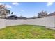 Backyard featuring a white fence and lush green grass at 2685 Rainbow Springs Ln, Orlando, FL 32828