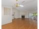 Bright living room with wood floors, fireplace, chandelier, and sliding door access to outside at 26913 Forest Hills St, Leesburg, FL 34748