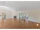 Bright and airy living room with wood floors, fireplace, ceiling fan, and screened-in porch at 26913 Forest Hills St, Leesburg, FL 34748