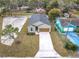 Aerial view of a one story home with a gray roof, long driveway, and a landscaped yard at 281 Luis Ln, Debary, FL 32713