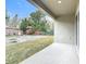 Covered back porch overlooking the yard with a mix of grass and natural landscaping at 281 Luis Ln, Debary, FL 32713