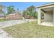 View of the backyard with a gravel parking area and a partial view of the patio at 281 Luis Ln, Debary, FL 32713