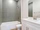 Modern bathroom with gray tiled shower, white vanity, and updated fixtures at 281 Luis Ln, Debary, FL 32713