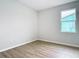 Light-filled bedroom with wood-look flooring and a window offering natural light at 281 Luis Ln, Debary, FL 32713