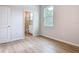 Bedroom features wood-look floors and bright bathroom at 281 Luis Ln, Debary, FL 32713