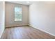 Bright bedroom features a window and wood-look flooring at 281 Luis Ln, Debary, FL 32713