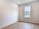Bright bedroom features a window and wood-look flooring at 281 Luis Ln, Debary, FL 32713