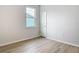 This is a bright bedroom featuring wood-look floors, neutral walls, and a window at 281 Luis Ln, Debary, FL 32713