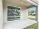 A large covered patio leads from an open backyard through sliding glass doors into the home at 281 Luis Ln, Debary, FL 32713