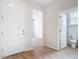 Bright entryway with wood-look flooring, white doors, and access to a bathroom and other rooms at 281 Luis Ln, Debary, FL 32713