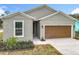 Beautiful one story home with a brown two car garage door and manicured front yard at 281 Luis Ln, Debary, FL 32713