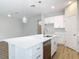 Kitchen island with stainless steel sink and quartz countertops and stainless steel dishwasher at 281 Luis Ln, Debary, FL 32713