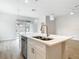 Kitchen island with stainless steel sink and quartz countertops and stainless steel dishwasher at 281 Luis Ln, Debary, FL 32713