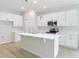 Modern kitchen with a center island, stainless steel appliances, and sleek white cabinetry at 281 Luis Ln, Debary, FL 32713