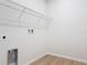 Laundry room with sleek wire shelving and wood-look flooring at 281 Luis Ln, Debary, FL 32713