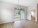 Open living room with stylish light fixture and sliding glass doors to the backyard at 281 Luis Ln, Debary, FL 32713