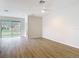 Bright, open living room with wood-look flooring and sliding glass doors to the backyard at 281 Luis Ln, Debary, FL 32713