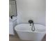 Modern soaking tub in the primary bathroom, featuring black hardware and clean lines at 2942 Sw 162Nd St, Ocala, FL 34473