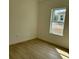 Neutral bedroom with wood-look floors and one window at 2942 Sw 162Nd St, Ocala, FL 34473