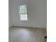 Bright bedroom featuring light wood floors and a window offering natural light at 2942 Sw 162Nd St, Ocala, FL 34473