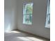 Bedroom with two windows and luxury vinyl plank flooring at 2942 Sw 162Nd St, Ocala, FL 34473