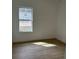 A light-filled bedroom with wood-style floors and a view of the neighborhood at 2942 Sw 162Nd St, Ocala, FL 34473