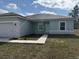 Well-manicured front yard with a sidewalk leading to the front door of this charming one-story home at 2942 Sw 162Nd St, Ocala, FL 34473