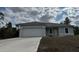 Charming one-story home with attached garage and a freshly poured concrete driveway at 2942 Sw 162Nd St, Ocala, FL 34473