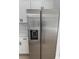 Modern, stainless steel refrigerator and freezer combo complement the bright, white kitchen cabinets at 2942 Sw 162Nd St, Ocala, FL 34473
