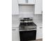 Close-up of a stainless steel stove and oven, along with crisp white cabinetry, and subway tile backsplash at 2942 Sw 162Nd St, Ocala, FL 34473