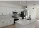 Modern kitchen featuring white cabinets, stainless steel appliances, and quartz countertops at 2942 Sw 162Nd St, Ocala, FL 34473