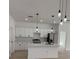 Well-lit kitchen with stainless steel appliances, white cabinets, quartz countertops, and modern pendant lighting at 2942 Sw 162Nd St, Ocala, FL 34473