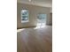 Bright living room featuring wood-look flooring, modern window and sliding glass door to the backyard at 2942 Sw 162Nd St, Ocala, FL 34473