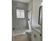 Modern bathroom featuring a tiled walk-in shower with black fixtures and window at 2942 Sw 162Nd St, Ocala, FL 34473