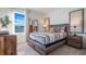 Well-lit bedroom featuring a large window, patterned bedding, and stylish side tables at 2993 Moulin Rd, Davenport, FL 33837