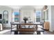 Dining area featuring a wooden table, bench, and large windows at 2993 Moulin Rd, Davenport, FL 33837