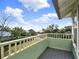 Charming outdoor balcony with beautiful views of a lush lawn, gorgeous foliage, and blue skies with fluffy white clouds at 340 W 9Th Ave, Mount Dora, FL 32757