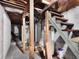 Unfinished basement with exposed beams, concrete walls, and a wooden staircase, offering potential for customization at 340 W 9Th Ave, Mount Dora, FL 32757