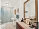 Bathroom with vanity, toilet, shower with curtain and vintage tile floor at 340 W 9Th Ave, Mount Dora, FL 32757