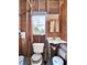 Bathroom featuring essential fixtures and plywood walls, providing a blank canvas for renovation projects at 340 W 9Th Ave, Mount Dora, FL 32757