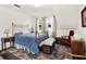 Cozy bedroom with a brass bed frame, antique furnishings, and bright natural light at 340 W 9Th Ave, Mount Dora, FL 32757