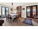 Elegant dining room with chandelier, glass paneled doors, and a large wooden hutch for storage at 340 W 9Th Ave, Mount Dora, FL 32757