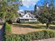 Charming two-story home featuring a screened porch, lush landscaping and a metal roof at 340 W 9Th Ave, Mount Dora, FL 32757