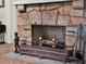 Unique stone fireplace with detailed metalwork and vintage decor, offering a classic, sophisticated ambiance at 340 W 9Th Ave, Mount Dora, FL 32757