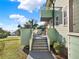 Outdoor patio with white seating, a green umbrella, and a staircase overlooking the surrounding landscape at 340 W 9Th Ave, Mount Dora, FL 32757
