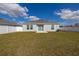 Home's backyard offers a large grassy area, perfect for outdoor activities, and a private, fenced-in space at 350 Rustic Rail Dr, Lake Wales, FL 33859