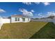 Spacious backyard features a privacy fence, lush green grass, and a cozy patio area at 350 Rustic Rail Dr, Lake Wales, FL 33859