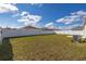 Expansive backyard boasts a lush lawn, offering ample space for recreation and relaxation under the blue sky at 350 Rustic Rail Dr, Lake Wales, FL 33859